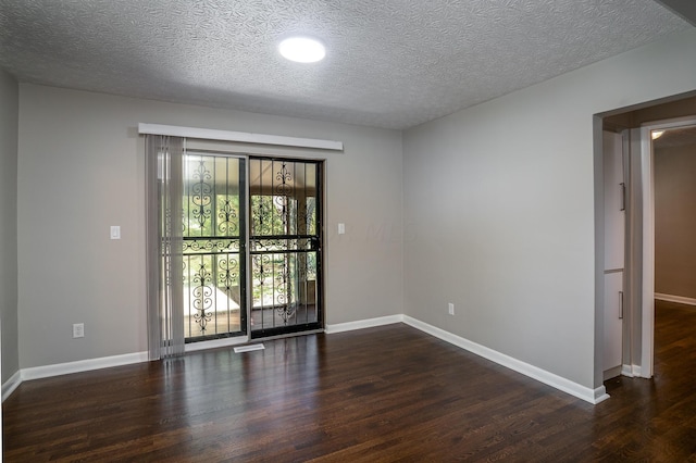 unfurnished room featuring a textured ceiling and dark wood-type flooring