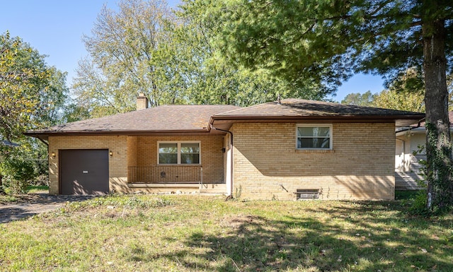 ranch-style house featuring a garage and a front yard