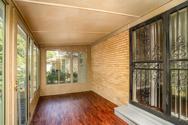 unfurnished sunroom with lofted ceiling