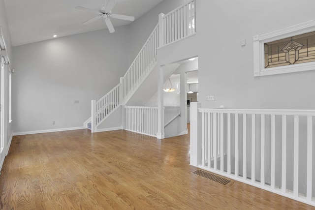 unfurnished living room with light hardwood / wood-style flooring and ceiling fan