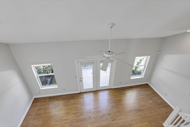 unfurnished living room with dark hardwood / wood-style flooring, vaulted ceiling, and a healthy amount of sunlight