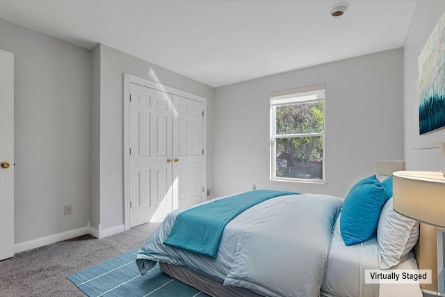 bedroom with light carpet and a closet