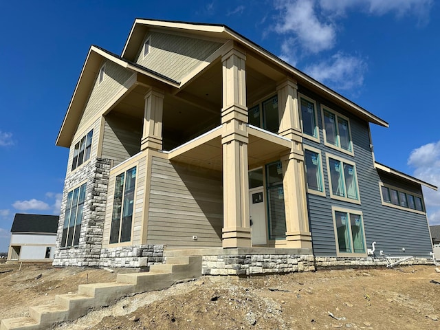 exterior space with covered porch and a balcony