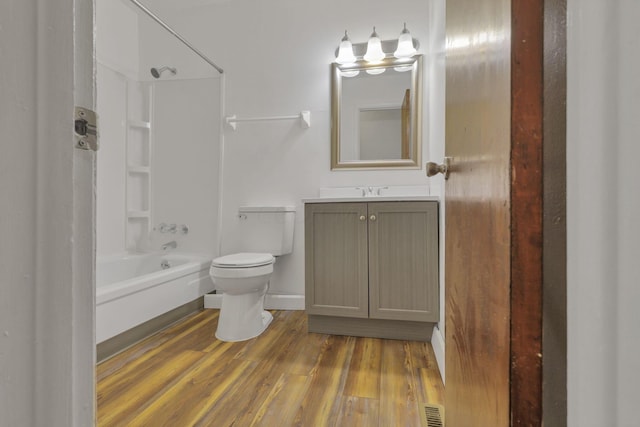 full bathroom featuring vanity, toilet, wood-type flooring, and shower / washtub combination