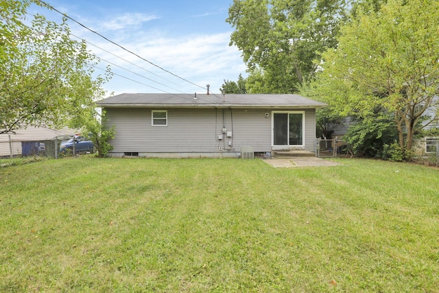 rear view of house with a yard