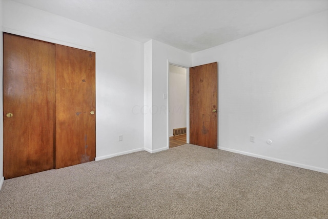 unfurnished bedroom with carpet and a closet