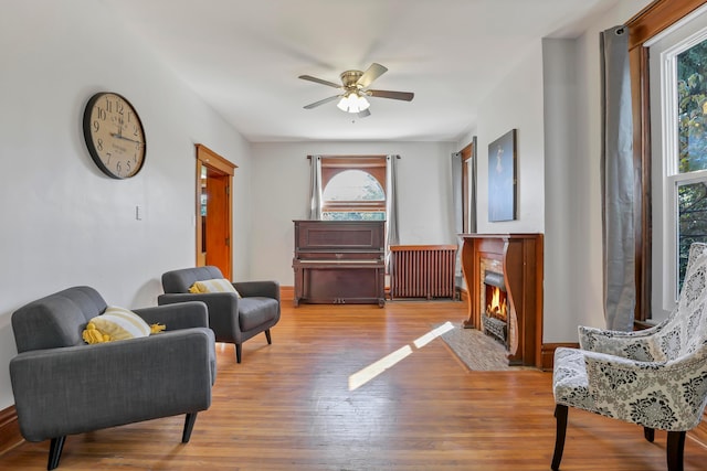 sitting room featuring a wealth of natural light, ceiling fan, and light hardwood / wood-style floors