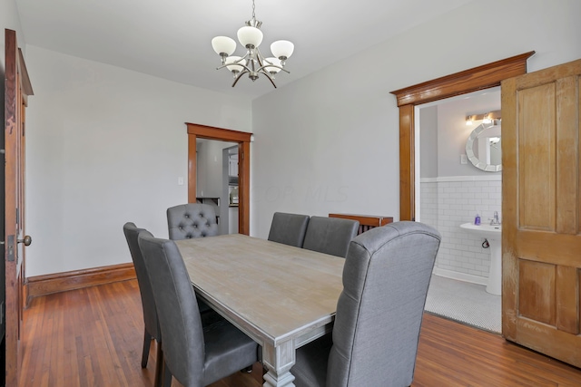 dining space with a notable chandelier and dark hardwood / wood-style flooring