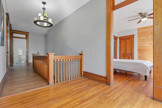 corridor featuring a chandelier and light hardwood / wood-style flooring