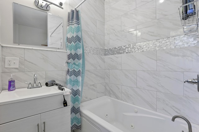 bathroom featuring shower / bath combination with curtain, vanity, and tile walls