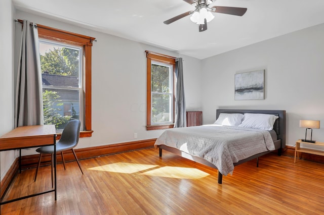 bedroom with light hardwood / wood-style flooring and ceiling fan