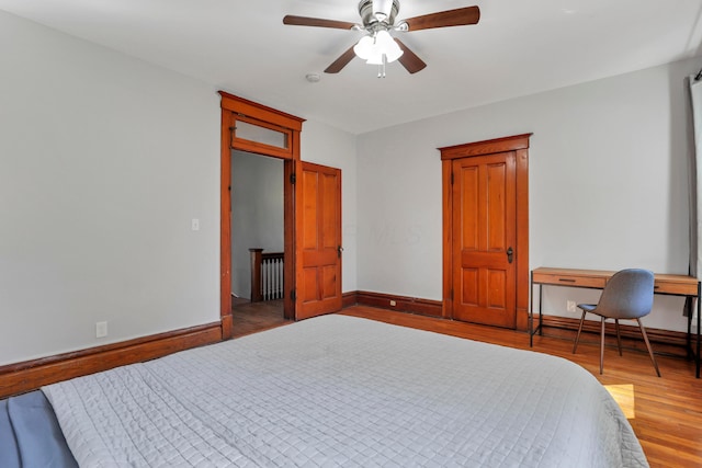 bedroom with wood-type flooring and ceiling fan