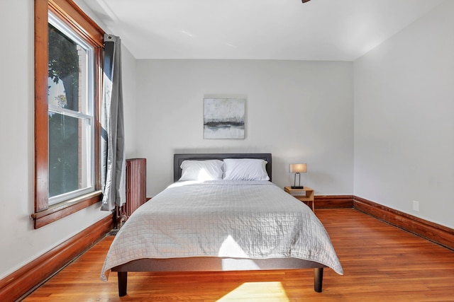 bedroom featuring wood-type flooring and multiple windows