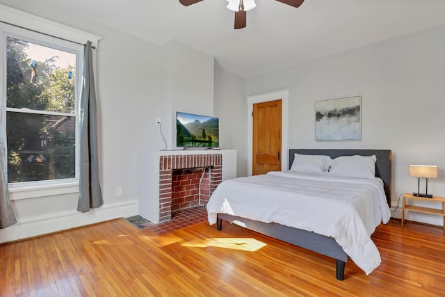 bedroom with ceiling fan and hardwood / wood-style floors