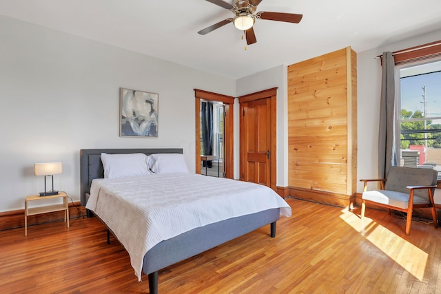 bedroom with ceiling fan and hardwood / wood-style flooring