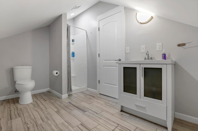 bathroom with vanity, a shower with door, wood-type flooring, toilet, and lofted ceiling