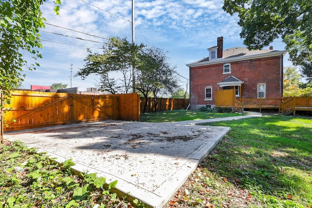 rear view of house featuring a yard and a deck