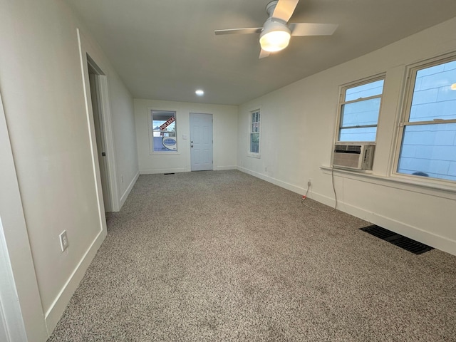 unfurnished room featuring carpet, cooling unit, and ceiling fan