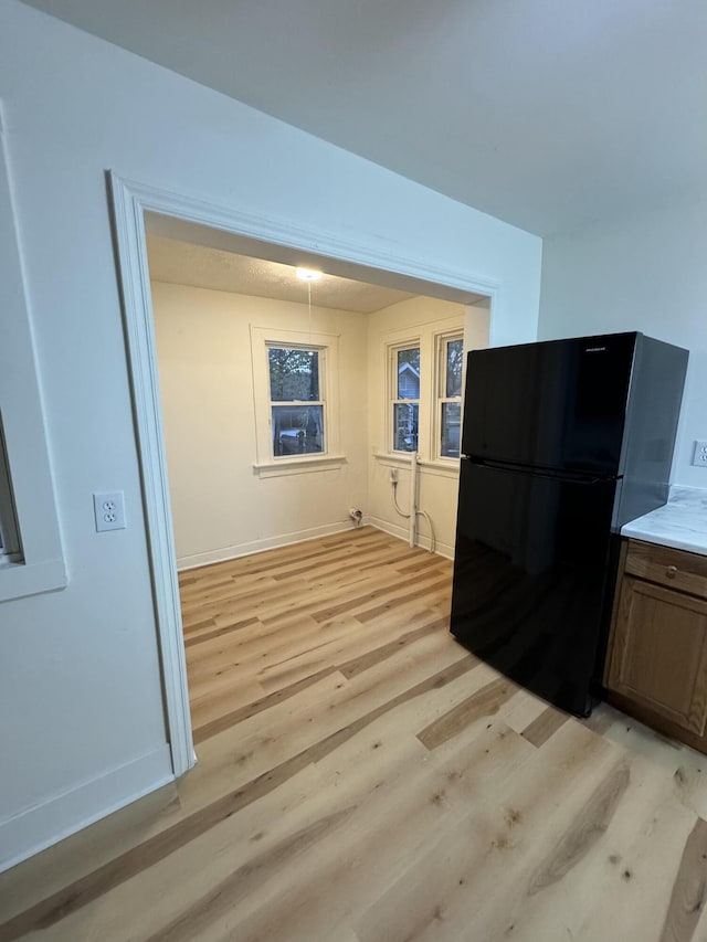 kitchen featuring black fridge and light wood-type flooring