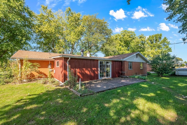 rear view of property with a patio area and a lawn