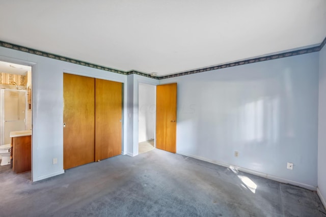 unfurnished bedroom featuring ensuite bath and a closet