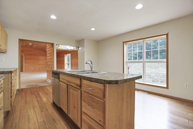 kitchen with sink, stainless steel dishwasher, an island with sink, wood-type flooring, and lofted ceiling