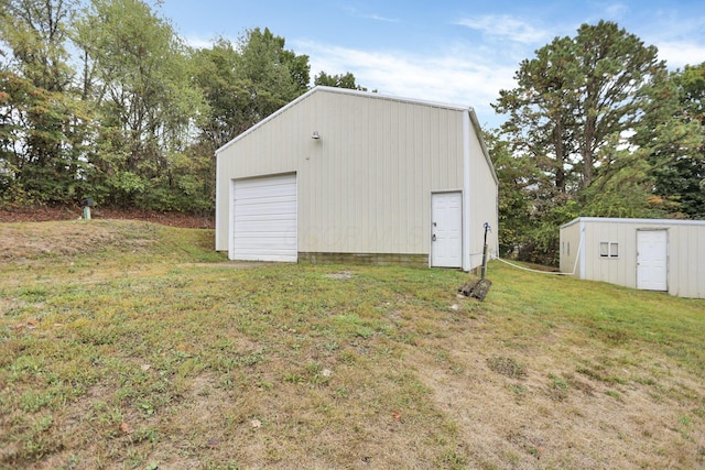 view of outbuilding with a garage and a lawn