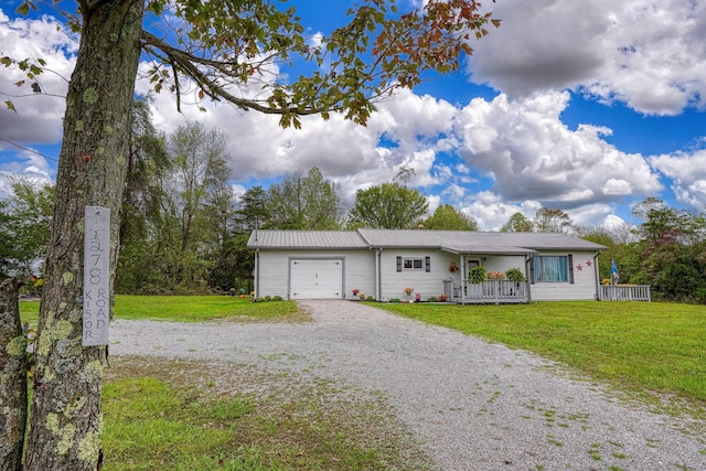 ranch-style home with covered porch, a garage, and a front yard