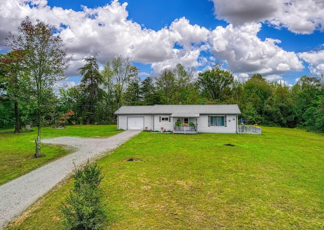 single story home with covered porch, a front yard, and a garage