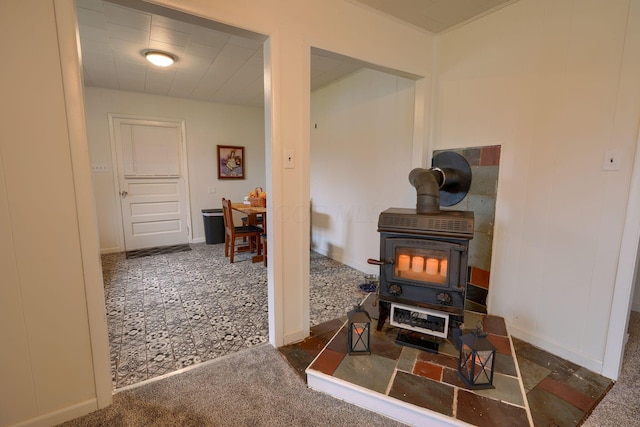 interior space with dark colored carpet and a wood stove