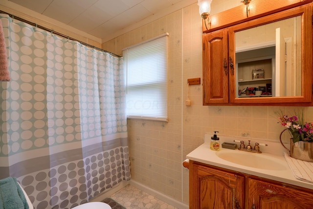 bathroom with a shower with shower curtain, vanity, and tile walls