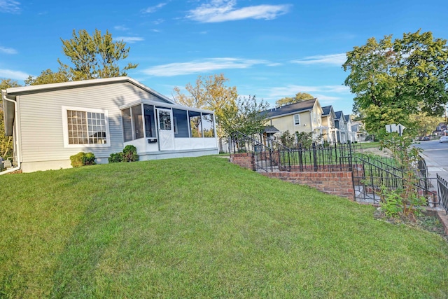 exterior space featuring a lawn and a sunroom