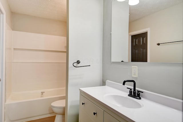 full bathroom featuring hardwood / wood-style floors, vanity, shower / bathing tub combination, toilet, and a textured ceiling