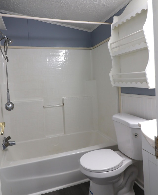 full bathroom featuring shower / bathing tub combination, vanity, toilet, and a textured ceiling