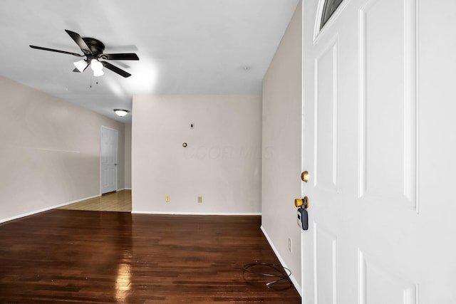 spare room with dark hardwood / wood-style floors and ceiling fan