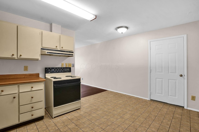 kitchen featuring cream cabinetry, white range with electric stovetop, and light tile patterned flooring