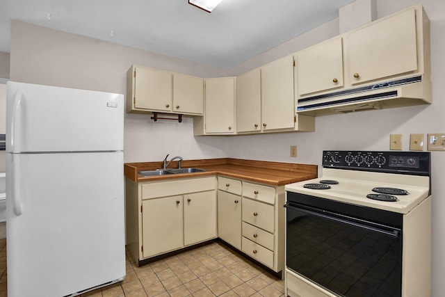 kitchen featuring cream cabinets, white appliances, light tile patterned floors, and sink