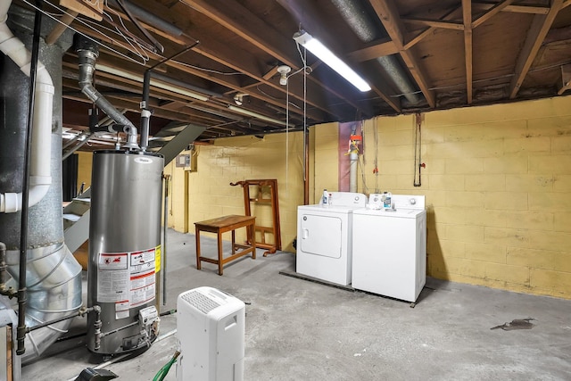 basement featuring washer and dryer and water heater