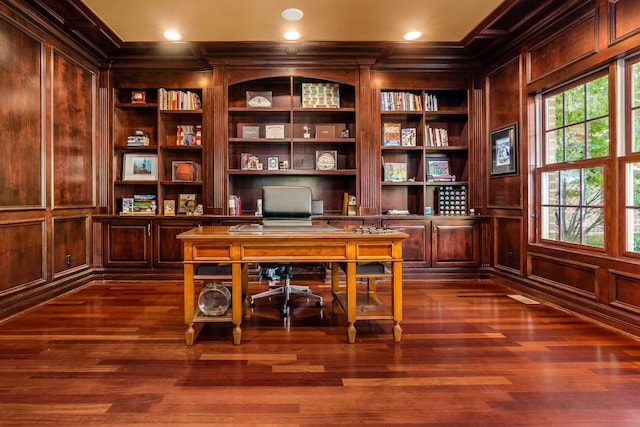 office with dark hardwood / wood-style floors, built in features, ornamental molding, and wood walls