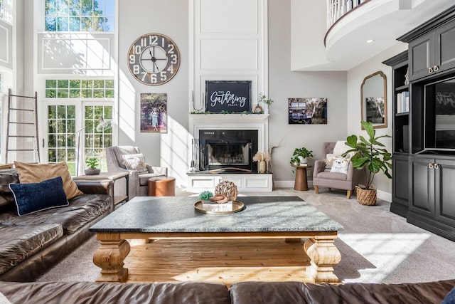 living room with carpet floors and a high ceiling