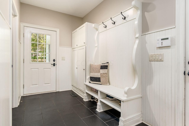 mudroom with wood walls