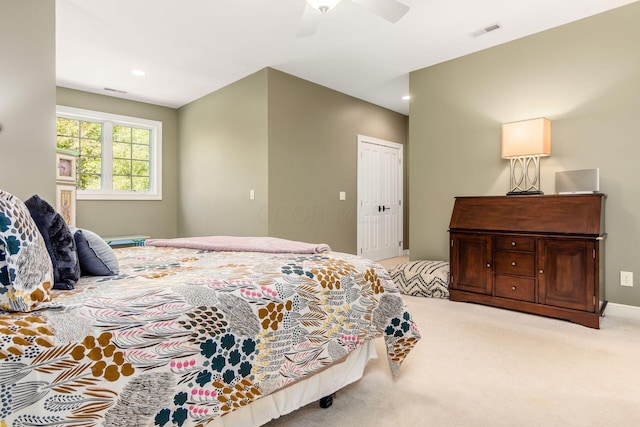 carpeted bedroom featuring a closet and ceiling fan