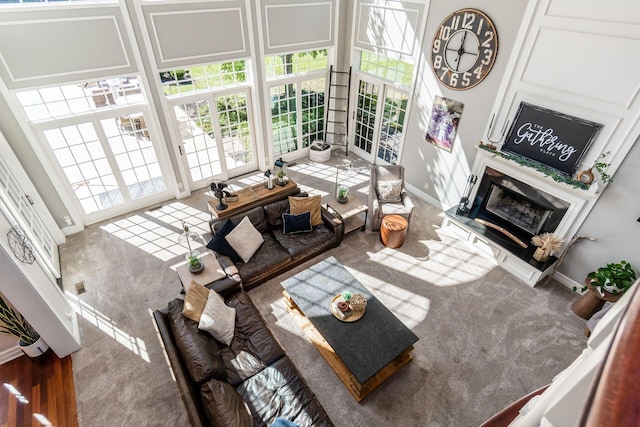 living room with hardwood / wood-style floors and a high end fireplace