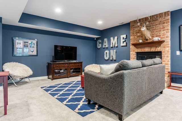 carpeted living room featuring a fireplace