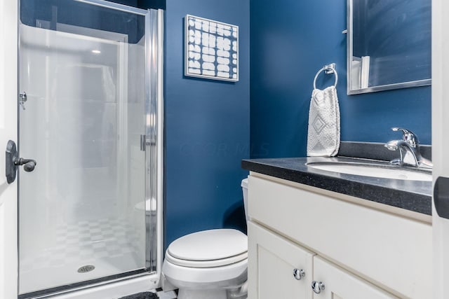 bathroom featuring walk in shower, vanity, and toilet