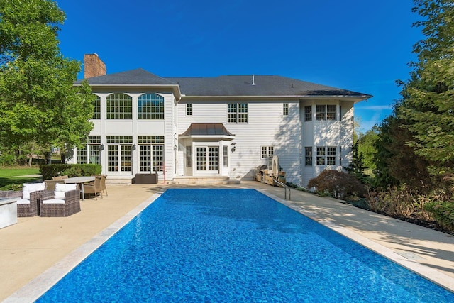 back of house featuring an outdoor living space, a patio area, and french doors