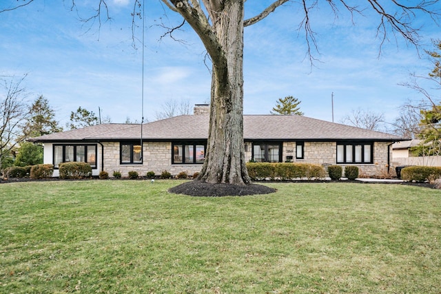 single story home featuring a front yard