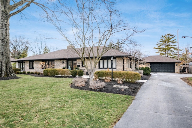 ranch-style home featuring a garage and a front yard