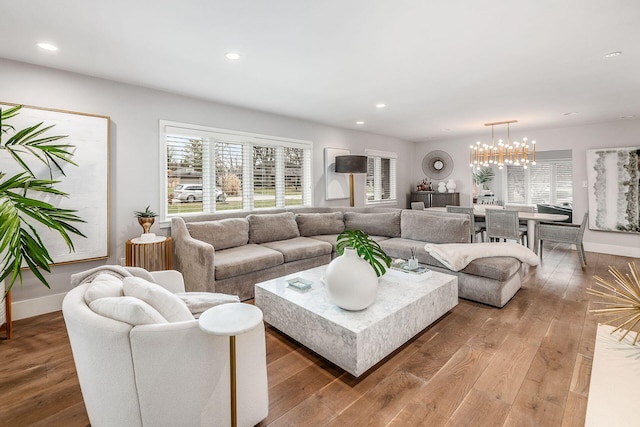 living room with wood-type flooring and an inviting chandelier