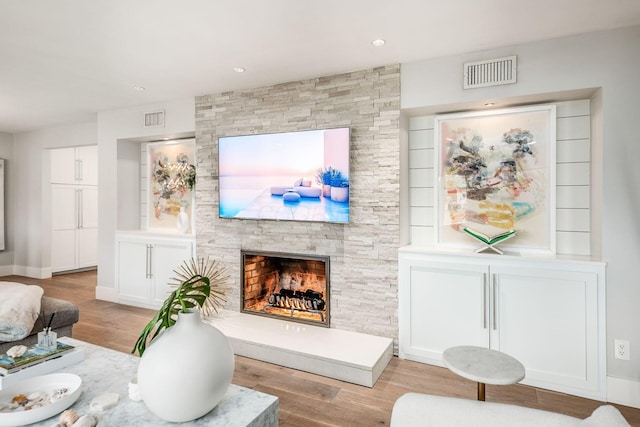 living room featuring a fireplace and light hardwood / wood-style floors